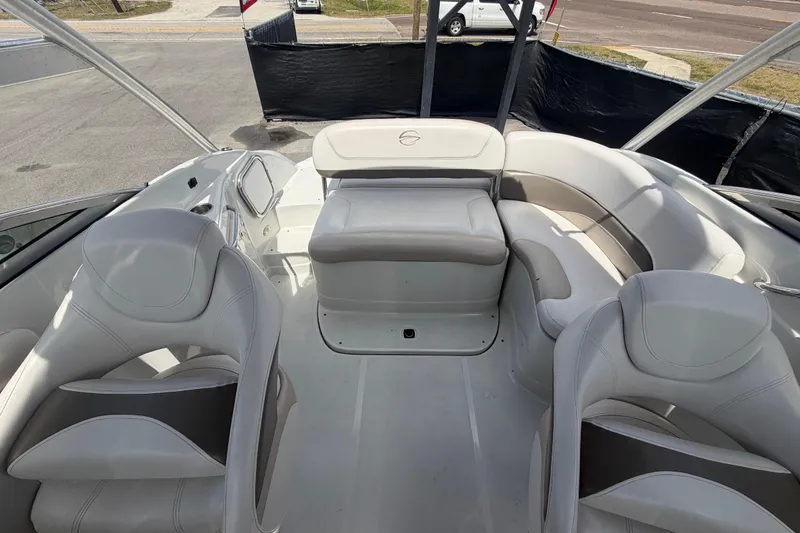 Slide: The Image of 2012 Crownline 236 SC boat interior with white seating and helm area. - 82