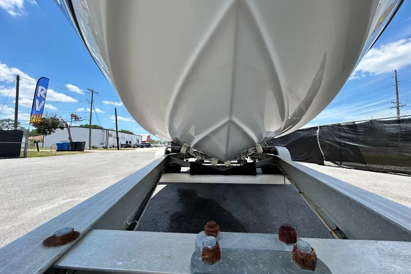 Slide: The Image of 2012 Crownline 236 SC boat on trailer, under clear blue sky. - 13