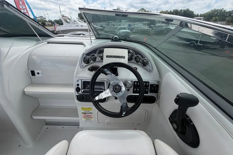 Slide: The Image of 2012 Crownline 236 SC boat dashboard with steering wheel and controls. - 34