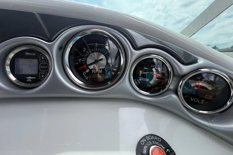 Slide: The Image of Dashboard of a 2012 Crownline 236 SC boat showing RPM, trim, and volt gauges. - 38