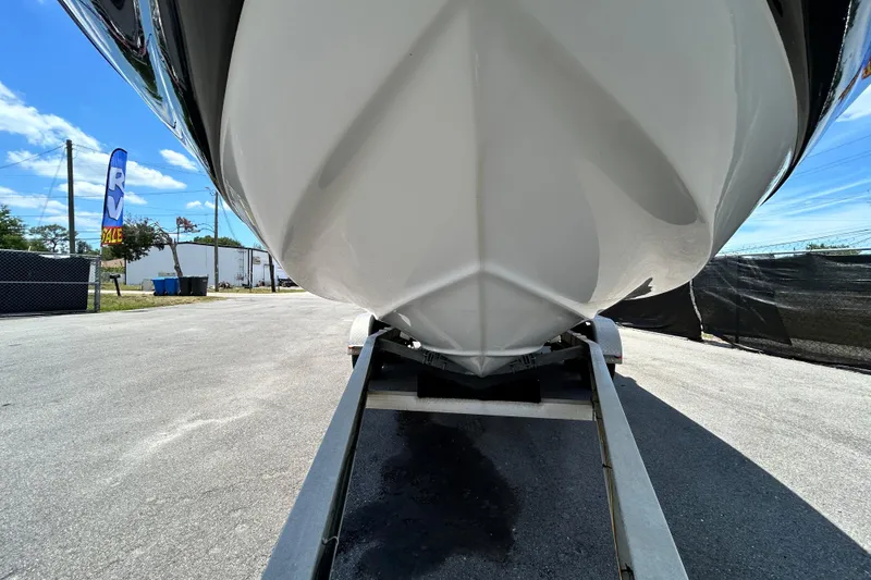 Slide: The Image of 2012 Crownline 236 SC boat on trailer, viewed from below, with clear blue sky. - 12