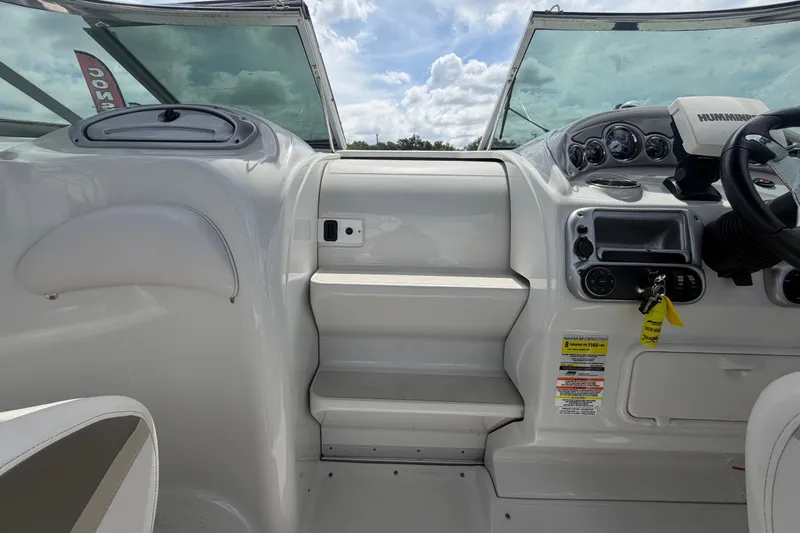 Slide: The Image of Interior view of a 2012 Crownline 236 SC boat cockpit with steering wheel and dashboard. - 51