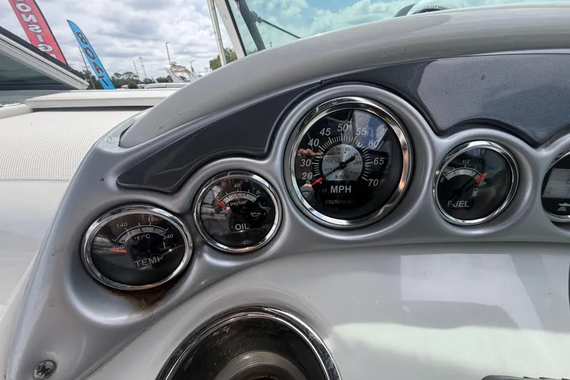 Slide: The Image of Dashboard of a 2012 Crownline 236 SC boat showing speedometer, oil, and fuel gauges. - 39