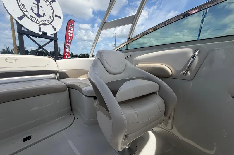 Slide: The Image of Interior of a 2012 Crownline 236 SC boat with plush seating and consignment signage. - 81