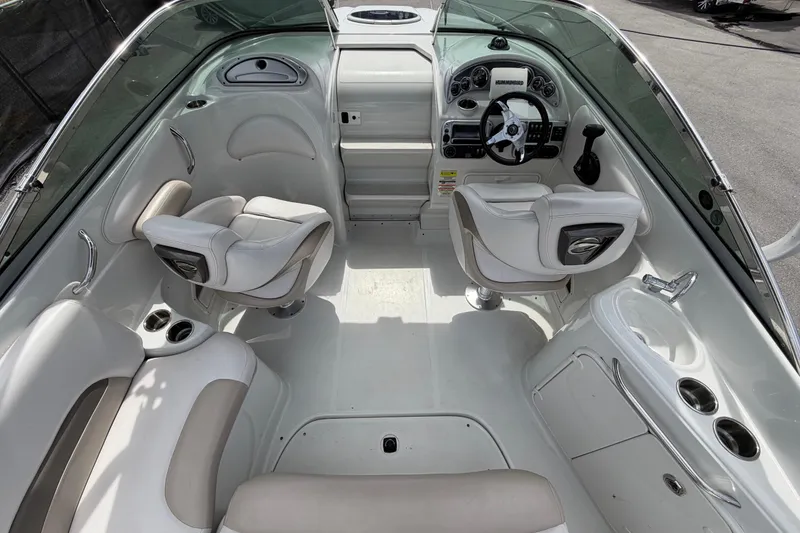 Slide: The Image of Interior of 2012 Crownline 236 SC boat with white seating and modern dashboard. - 23