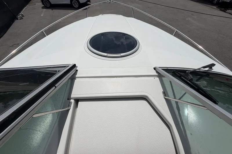 Slide: The Image of 2012 Crownline 236 SC boat deck with open hatch and windshield. - 72