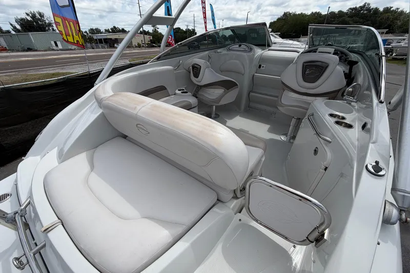 Slide: The Image of 2012 Crownline 236 SC boat interior with white seating and steering console. - 21