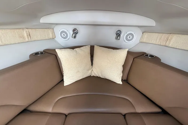 Slide: The Image of Interior cabin of 2012 Crownline 236 SC boat with brown seating and cushions. - 64