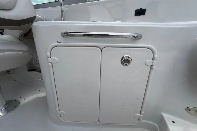 Slide: The Image of 2012 Crownline 236 SC boat interior with storage compartment and seating. - 26