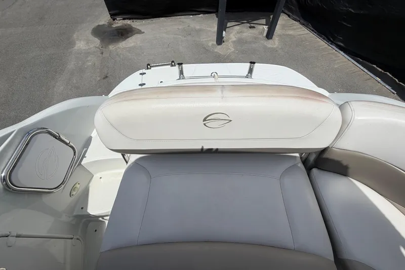 Slide: The Image of 2012 Crownline 236 SC boat interior with cushioned seating and logo detail. - 90
