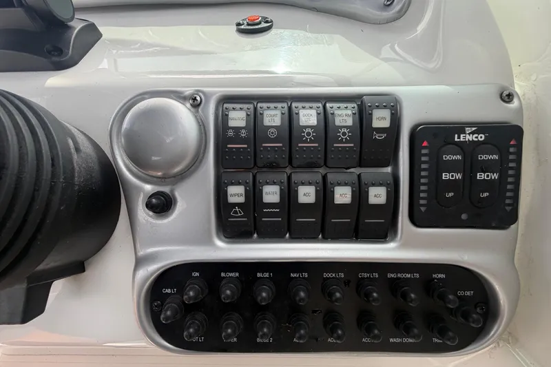 Slide: The Image of Control panel of a 2012 Crownline 236 SC boat with switches and Lenco trim tab controls. - 40