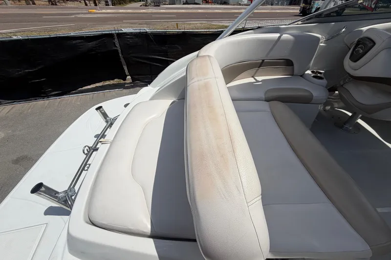 Slide: The Image of 2012 Crownline 236 SC boat interior with beige seating and cup holder. - 91