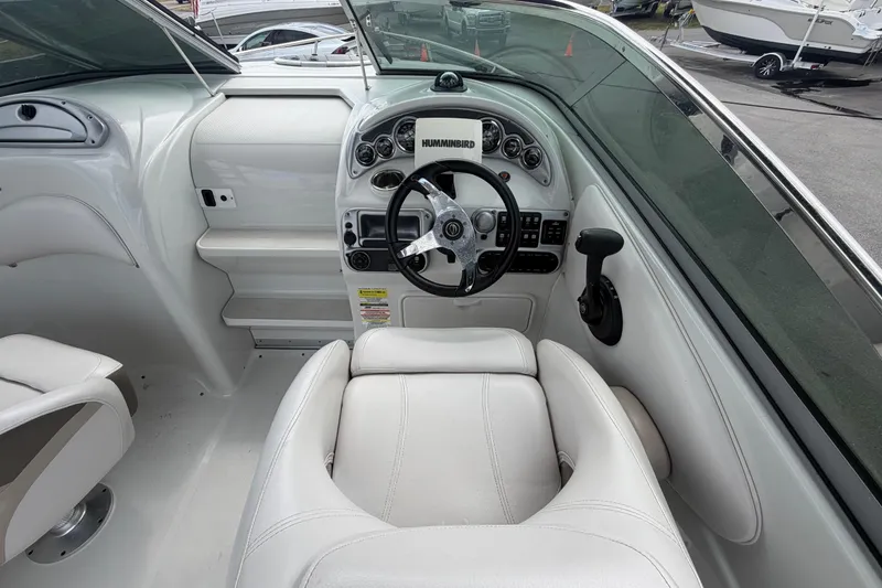 Slide: The Image of Interior view of 2012 Crownline 236 SC boat cockpit with steering wheel and controls. - 33