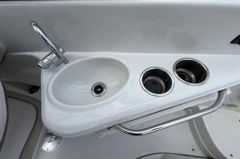 Slide: The Image of Crownline 236 SC 2012 boat sink with faucet and cup holders. - 28