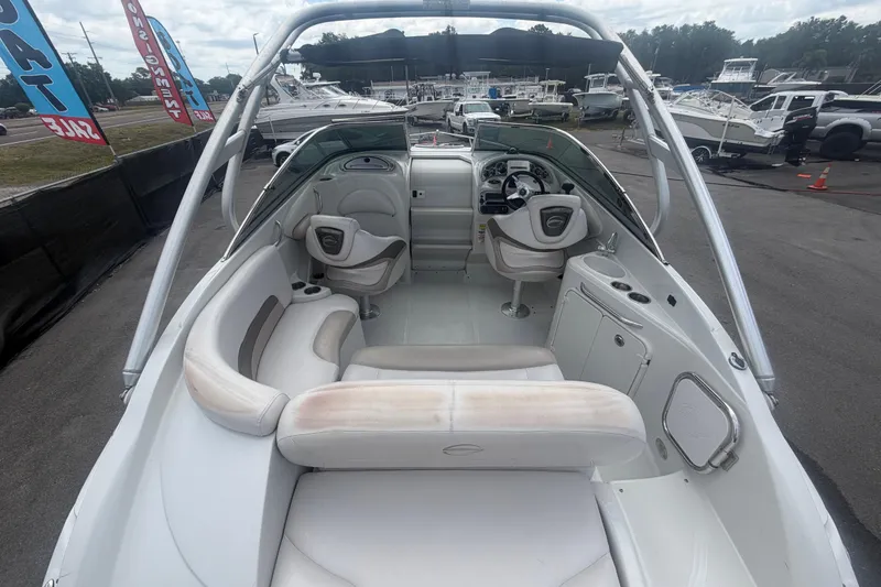 Slide: The Image of Interior view of a 2012 Crownline 236 SC boat, showcasing seating and helm. - 14