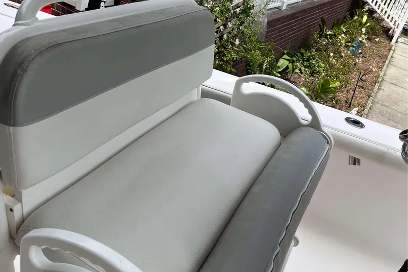 Slide: The Image of 2012 Everglades 243 Center Console boat seat with white and gray upholstery. - 5