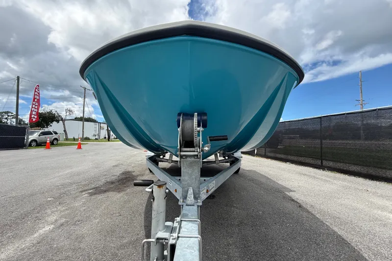 Slide: The Image of 2024 Bayliner Element M17 boat on trailer, viewed from front under cloudy sky. - 13