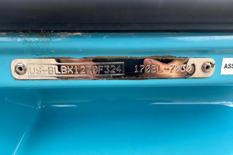 Slide: The Image of 2024 Bayliner Element M17 hull identification number plate on a blue surface. - 48