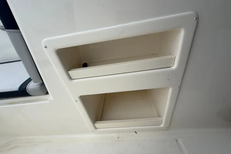 Slide: The Image of Storage compartments on a 2024 Bayliner Element M17 boat interior. - 26