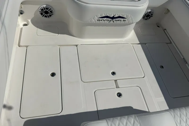 Slide: The Image of Deck of 2013 Invincible 36 Open Fisherman boat with storage compartments. - 12