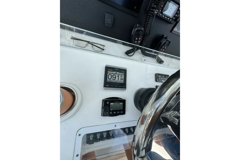 Slide: The Image of Console of 2013 Invincible 36 Open Fisherman with navigation instruments and steering wheel. - 16