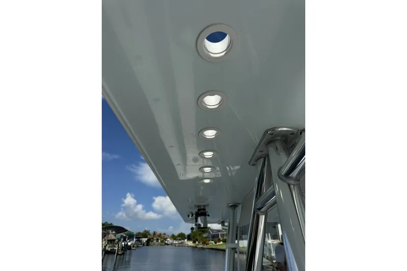 Slide: The Image of 2013 Invincible 36 Open Fisherman boat with overhead lights and clear sky. - 18