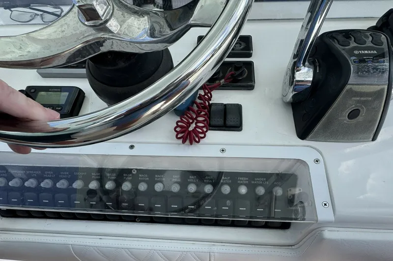 Slide: The Image of Console of 2013 Invincible 36 Open Fisherman with steering wheel and controls. - 15