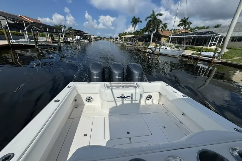 Slide: The Image of 2013 Invincible 36 Open Fisherman boat on a scenic canal with palm trees. - 13