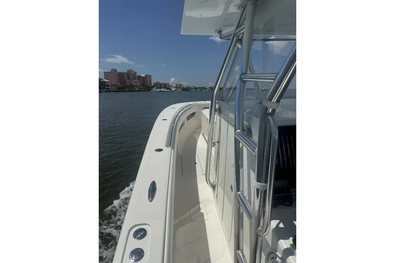 Slide: The Image of 2013 Invincible 36 Open Fisherman boat cruising on a sunny day near city skyline. - 8