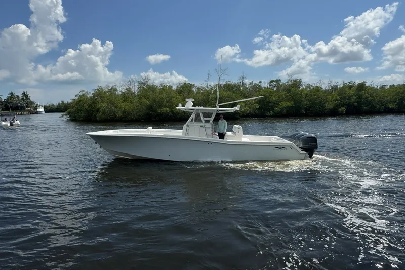 Slide: The Image of 2013 Invincible 36 Open Fisherman boat cruising on a sunny day. - 2