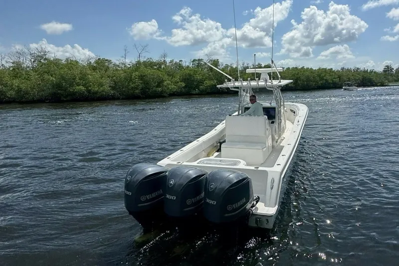 Slide: The Image of 2013 Invincible 36 Open Fisherman boat with triple Yamaha engines on a sunny day. - 3