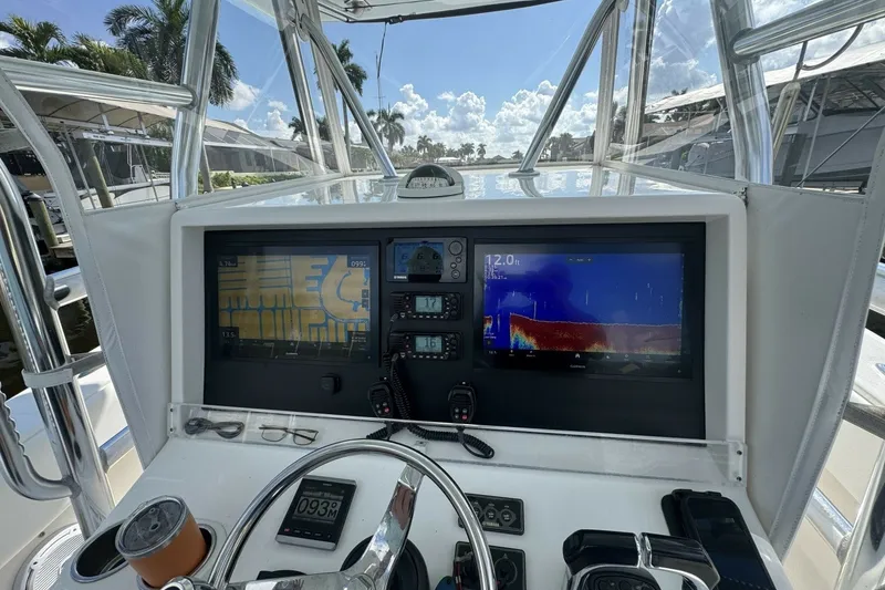 Slide: The Image of Helm of 2013 Invincible 36 Open Fisherman with navigation screens and controls. - 17