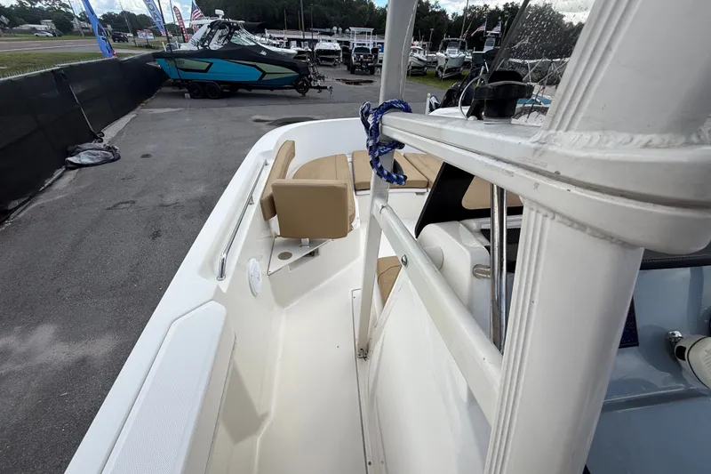 Slide: The Image of 2024 Bayliner Trophy T22CC boat interior with tan seating and white deck. - 31