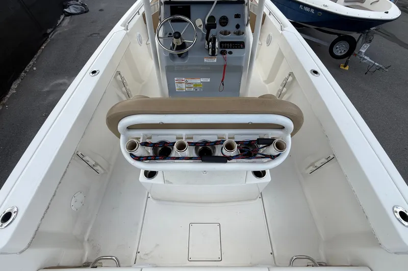 Slide: The Image of 2024 Bayliner Trophy T22CC boat interior with steering console and rod holders. - 18