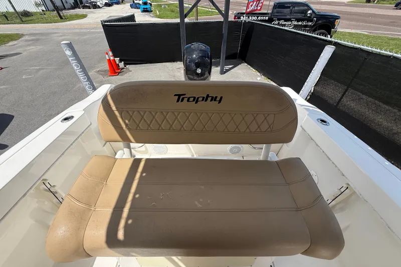 Slide: The Image of 2024 Bayliner Trophy T22CC boat with tan seating and "Trophy" logo. - 56