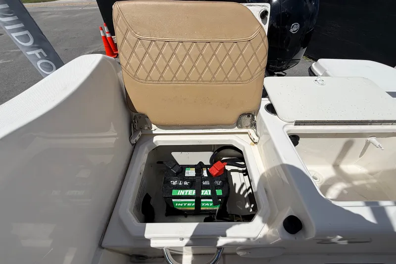 Slide: The Image of 2024 Bayliner Trophy T22CC boat battery compartment with seat open, showcasing interior storage. - 60