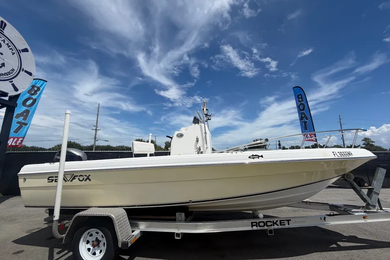 Slide: The Image of 2005 Sea Fox 197 Center Console boat on trailer under clear blue sky. - 1