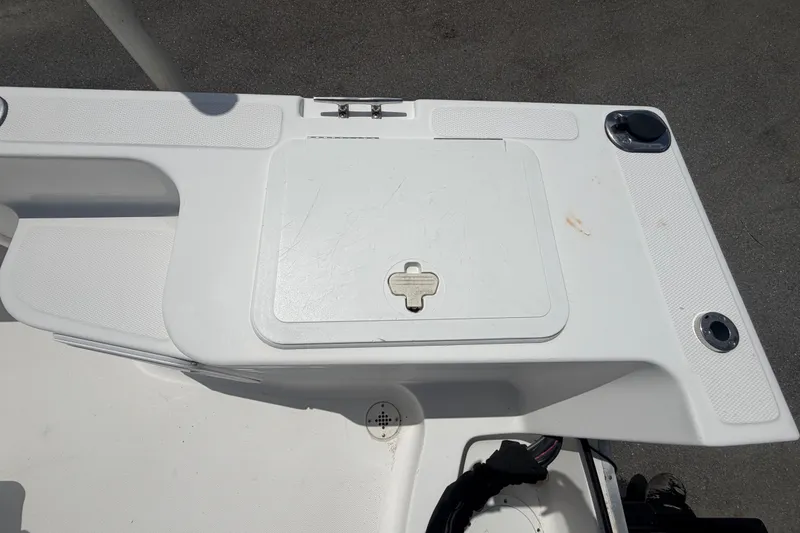 Slide: The Image of 2005 Sea Fox 197 Center Console boat deck with storage compartment and rod holders. - 44