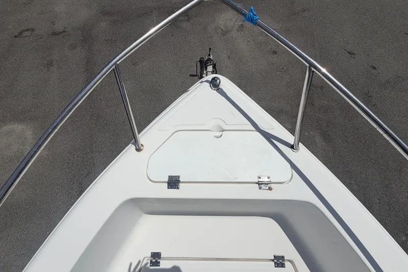 Slide: The Image of Bow view of a 2005 Sea Fox 197 Center Console boat, featuring stainless steel railings. - 28