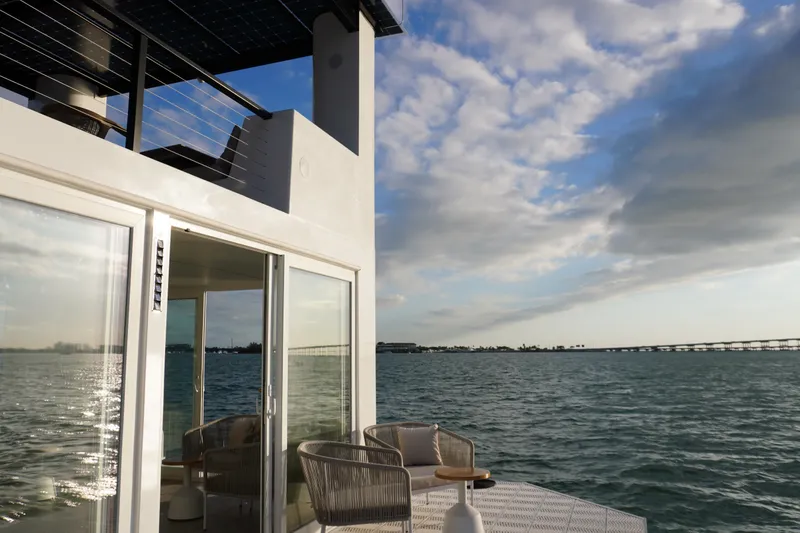 Slide: The Image of Floating Arkhaus Villa 50, 2025 model, with modern design on serene water. - 7