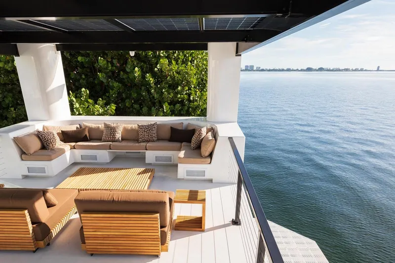 Slide: The Image of Luxurious Arkhaus Villa 50 terrace with modern seating, overlooking serene waterfront, 2025 model. - 9