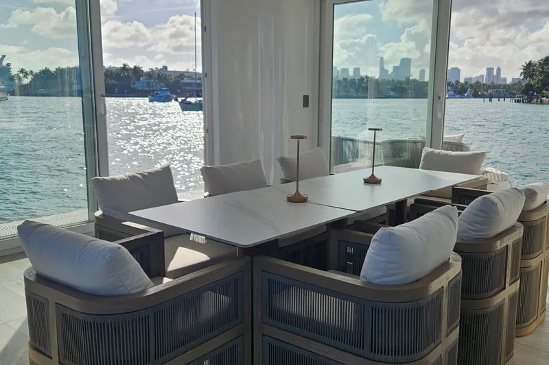 Slide: The Image of Modern dining area in Arkhaus Villa 50, 2025, with waterfront views and elegant seating. - 5
