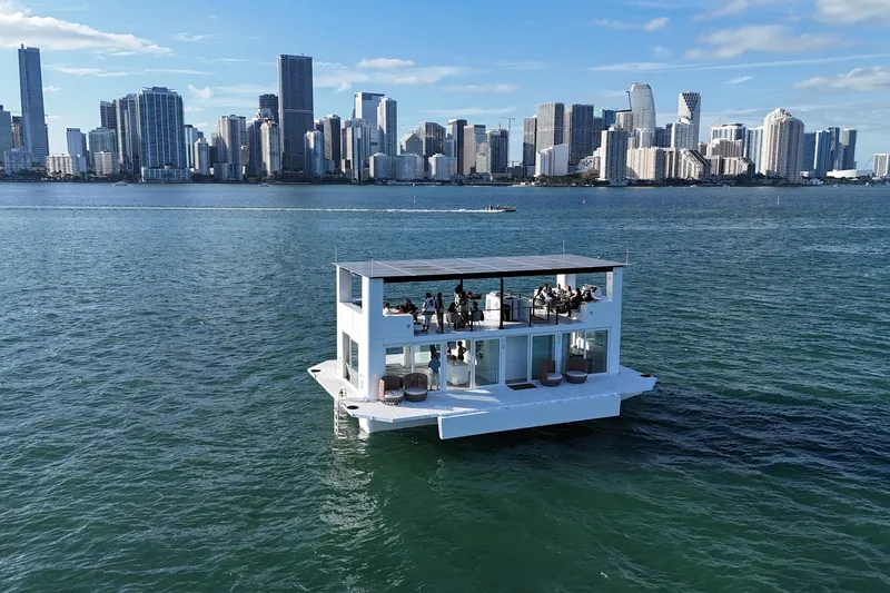 Slide: The Image of Floating Arkhaus Villa 50 on water with city skyline in background, 2025 model. - 15