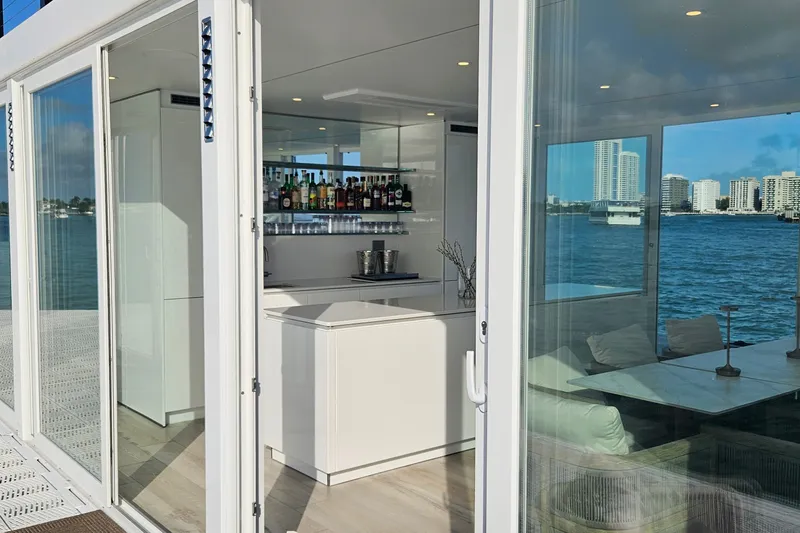 Slide: The Image of Modern Arkhaus Villa 50 interior with bar, overlooking waterfront cityscape, 2025 model. - 4