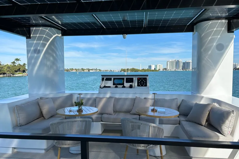 Slide: The Image of Luxurious Arkhaus Villa 50 yacht interior with waterfront view, featuring modern seating and decor, 2025 model. - 8