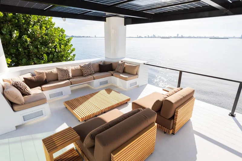 Slide: The Image of Luxurious Arkhaus Villa 50 terrace with modern seating, overlooking serene waterfront, 2025 model. - 3