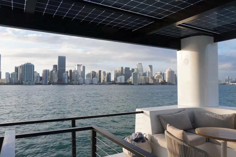 Slide: The Image of Modern Arkhaus Villa 50 with city skyline view, featuring solar panels and luxurious seating, 2025 model. - 11