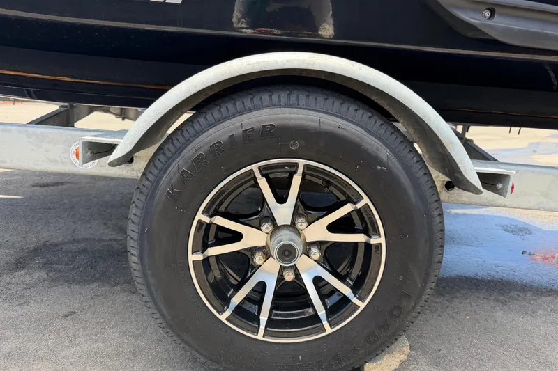 Slide: The Image of Trailer wheel for 2024 Kawasaki Jetski STX 160LX on pavement. - 49