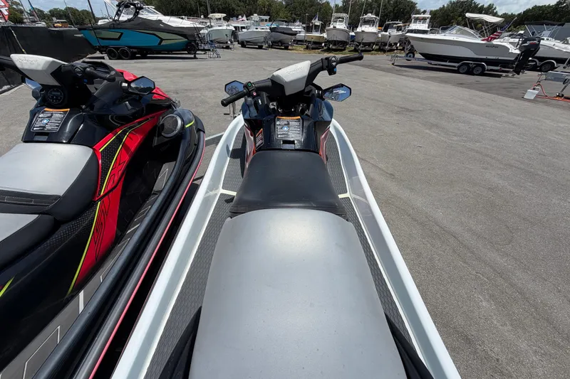 Slide: The Image of 2024 Kawasaki Jetski STX 160LX parked among boats at a marina. - 29