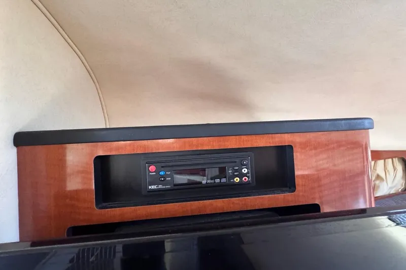 Slide: The Image of 2005 Sea Ray 300 Sundancer cabin with built-in entertainment system. - 60